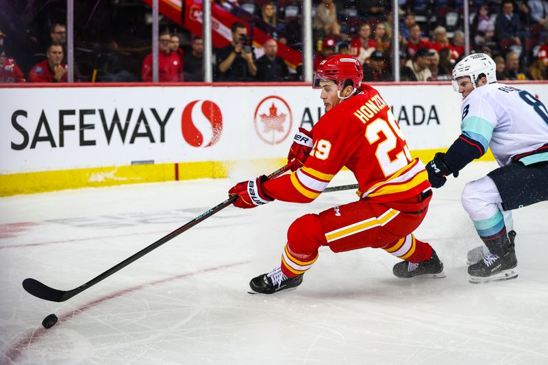 Sep 23, 2025; Calgary, Alberta, CAN; Calgary Flames left wing Samuel Honzek (29) controls the puck against Seattle Kraken defenseman Cale Fleury (8) during the second period at Scotiabank Saddledome. Mandatory Credit: Sergei Belski-Imagn Images