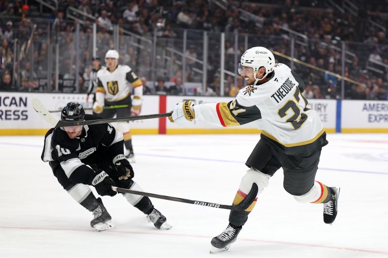 Oct 30, 2024; Los Angeles, California, USA;  Vegas Golden Knights defenseman Shea Theodore (27) shoots the puck as Los Angeles Kings left wing Tanner Jeannot (10) defends during the first period at Crypto.com Arena. Mandatory Credit: Kiyoshi Mio-Imagn Images