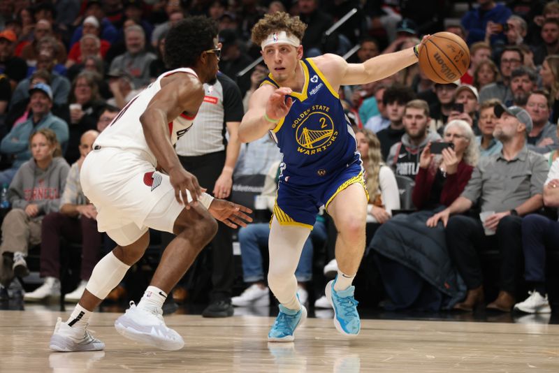 PORTLAND, OREGON - APRIL 11: Brandin Podziemski #2 of the Golden State Warriors drives against Scoot Henderson #00 of the Portland Trail Blazers during the second quarter at Moda Center on April 11, 2024 in Portland, Oregon. NOTE TO USER: User expressly acknowledges and agrees that, by downloading and or using this photograph, User is consenting to the terms and conditions of the Getty Images License Agreement.? (Photo by Amanda Loman/Getty Images)