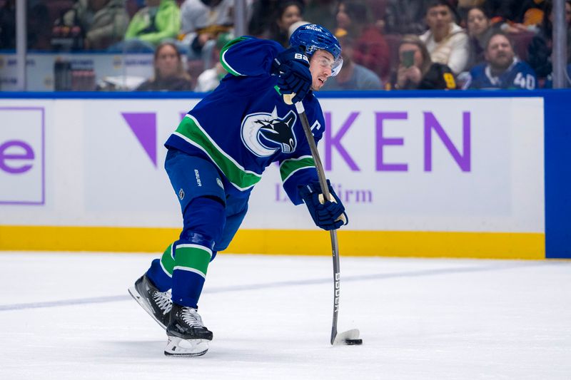 Nov 17, 2024; Vancouver, British Columbia, CAN; Vancouver Canucks defenseman Quinn Hughes (43) shoots against the Nashville Predators during the first period at Rogers Arena. Mandatory Credit: Bob Frid-Imagn Images