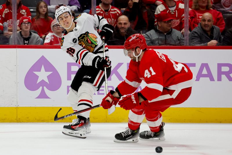 Nov 30, 2023; Detroit, Michigan, USA; Chicago Blackhawks center Connor Bedard (98) skates with the puck defended by Detroit Red Wings defenseman Shayne Gostisbehere (41) in the third period at Little Caesars Arena. Mandatory Credit: Rick Osentoski-USA TODAY Sports