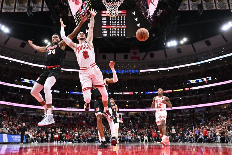 CHICAGO, ILLINOIS - MARCH 18:  Alex Caruso #6 of the Chicago Bulls loses the ball after being fouled as Jabari Walker #34 of the Portland Trail Blazers trails in the second half on March 18, 2024 at United Center in Chicago, Illinois. Chicago defeated Portland 110-107.   NOTE TO USER: User expressly acknowledges and agrees that, by downloading and or using this photograph, User is consenting to the terms and conditions of the Getty Images License Agreement.  (Photo by Jamie Sabau/Getty Images)