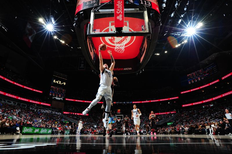 ATLANTA, GA - APRIL 2: Luka Doncic #77 of the Dallas Mavericks drives to the basket during the game against the Atlanta Hawks on April 2, 2023 at State Farm Arena in Atlanta, Georgia.  NOTE TO USER: User expressly acknowledges and agrees that, by downloading and/or using this Photograph, user is consenting to the terms and conditions of the Getty Images License Agreement. Mandatory Copyright Notice: Copyright 2023 NBAE (Photo by Scott Cunningham/NBAE via Getty Images)