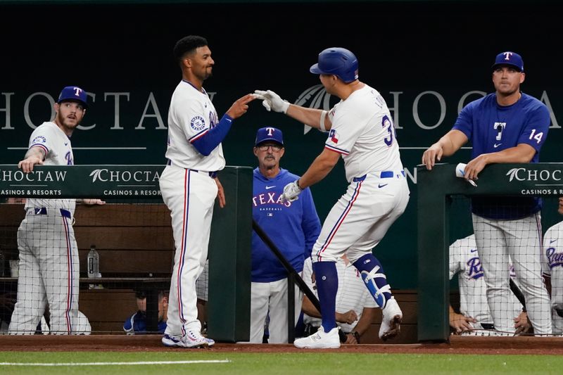 Apr 25, 2024; Arlington, Texas, USA; Texas Rangers first baseman Nathaniel Lowe (30) reacts with second baseman Marcus Semien (2) after hitting a solo home run during the first inning against the Seattle Mariners at Globe Life Field. Mandatory Credit: Raymond Carlin III-USA TODAY Sports