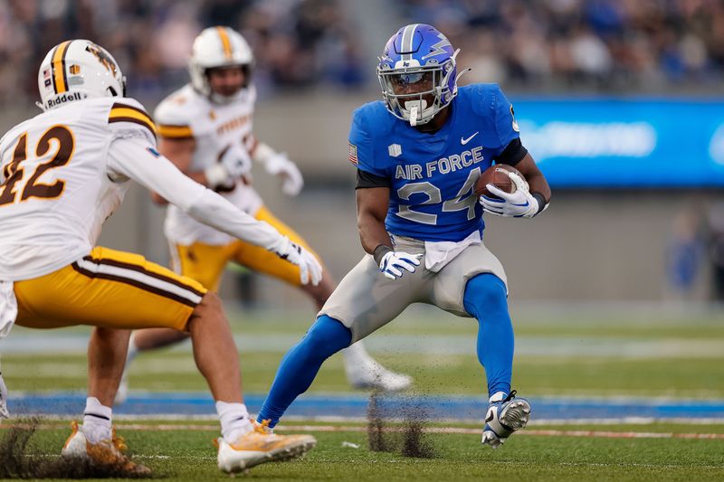 Oct 14, 2023; Colorado Springs, Colorado, USA; Air Force Falcons running back John Lee Eldridge III (24) runs the ball against Wyoming Cowboys safety Isaac White (42) in the second quarter at Falcon Stadium. Mandatory Credit: Isaiah J. Downing-USA TODAY Sports