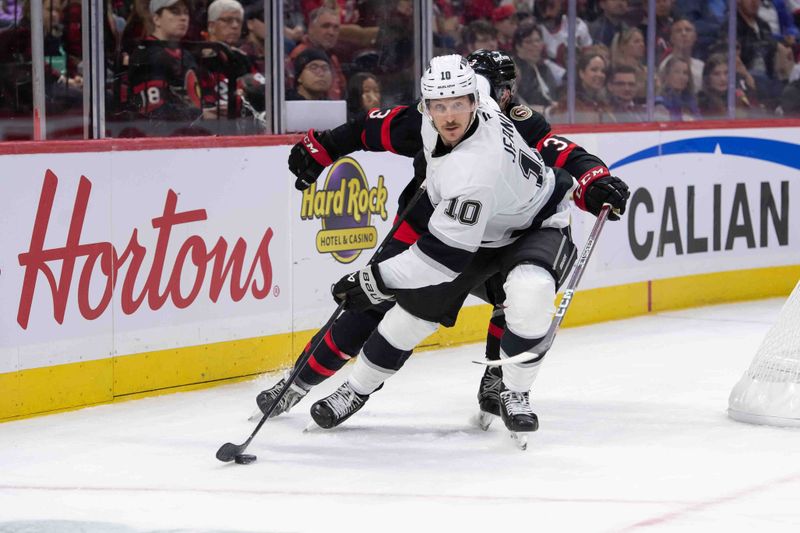 Oct 14, 2024; Ottawa, Ontario, CAN; Los Angeles Kings left wing Tanner Jeannot (10) moves the puck away from Ottawa Senators defenseman Nick Jensen (3) in the second period at the Canadian Tire Centre. Mandatory Credit: Marc DesRosiers-Imagn Images