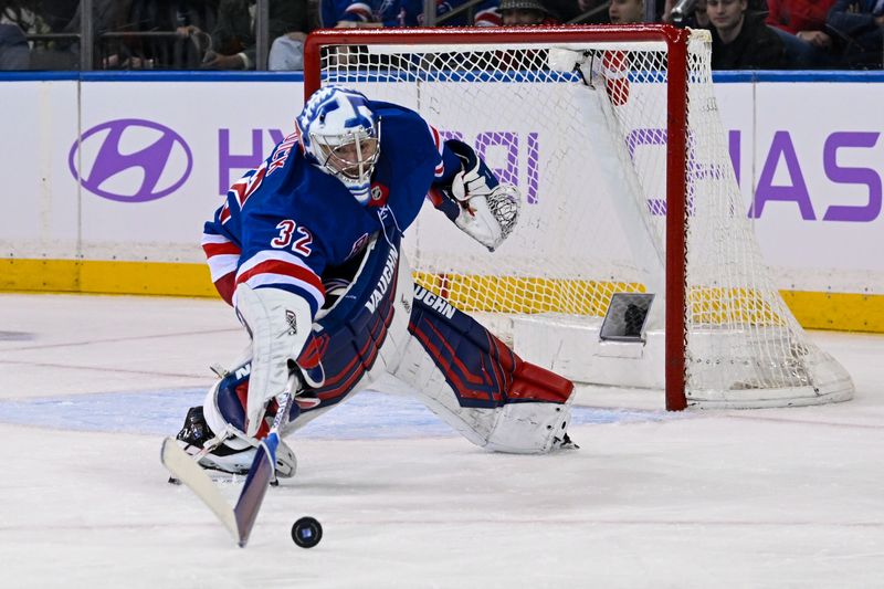 Jan 7, 2025; New York, New York, USA;  New York Rangers goaltender Jonathan Quick (32) pokes the puck with his stick against the Dallas Stars during the second period at Madison Square Garden. Mandatory Credit: Dennis Schneidler-Imagn Images