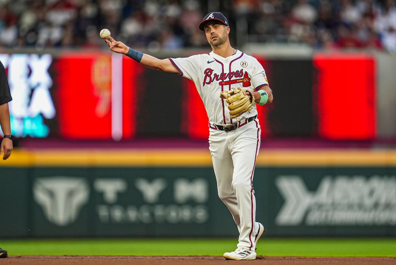 Sep 15, 2024; Cumberland, Georgia, USA; Atlanta Braves left fielder Whit Merrifield (15) throws out a Los Angeles Dodgers batter during the first inning at Truist Park. Mandatory Credit: Dale Zanine-Imagn Images