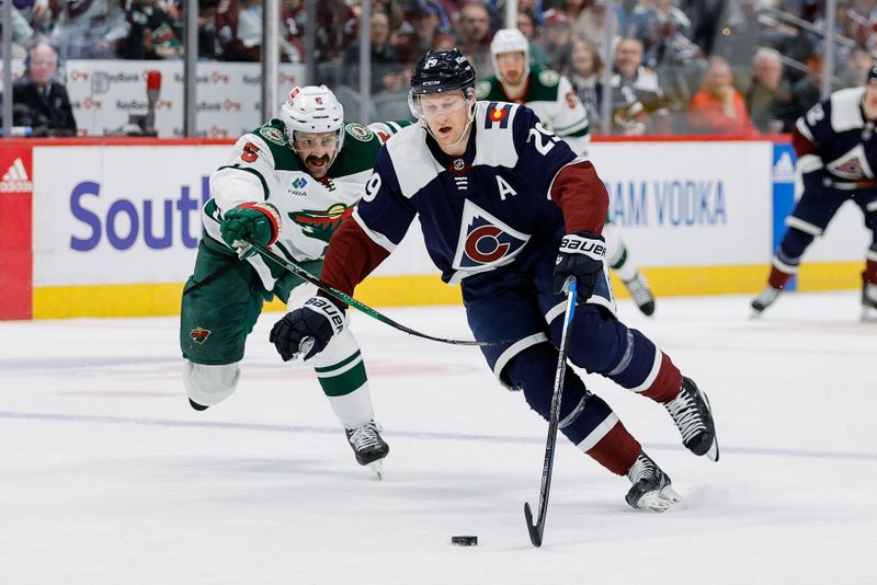 Apr 9, 2024; Denver, Colorado, USA; Colorado Avalanche center Nathan MacKinnon (29) controls the puck ahead of Minnesota Wild defenseman Jake Middleton (5) in the second period at Ball Arena. Mandatory Credit: Isaiah J. Downing-USA TODAY Sports