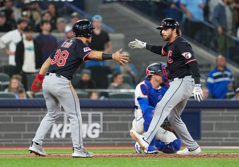 May 3, 2025; Toronto, Ontario, CAN; Cleveland Guardians second baseman Daniel Schneemann, right, celebrates his grand slam with left fielder Steven Kwan (38) against the Toronto Blue Jays at during the ninth inning at Rogers Centre. Mandatory Credit: Nick Turchiaro-Imagn Images