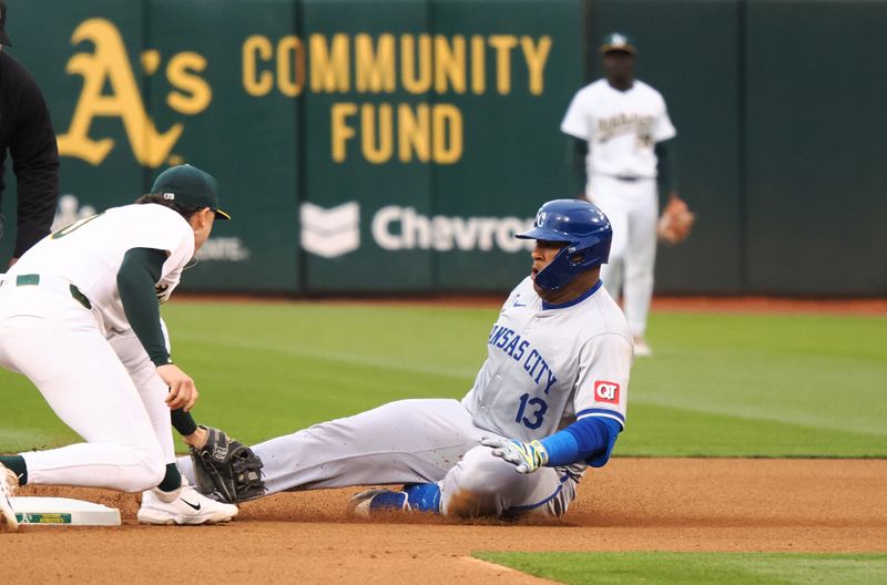 Jun 19, 2024; Oakland, California, USA; Oakland Athletics second baseman Zack Gelof (20) tags out Kansas City Royals catcher Salvador Perez (13) trying to reach second base during the fourth inning at Oakland-Alameda County Coliseum. Mandatory Credit: Kelley L Cox-USA TODAY Sports