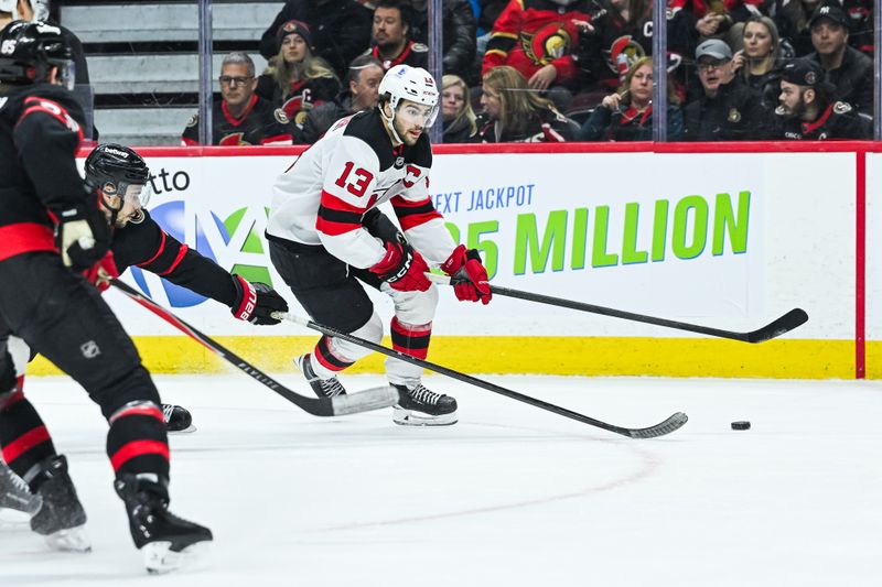 Jan 31, 2026; Ottawa, Ontario, CAN; New Jersey Devils center Nico Hischier (13) escapes with the puck against the Ottawa Senators during the second period at Canadian Tire Centre. Mandatory Credit: David Kirouac-Imagn Images