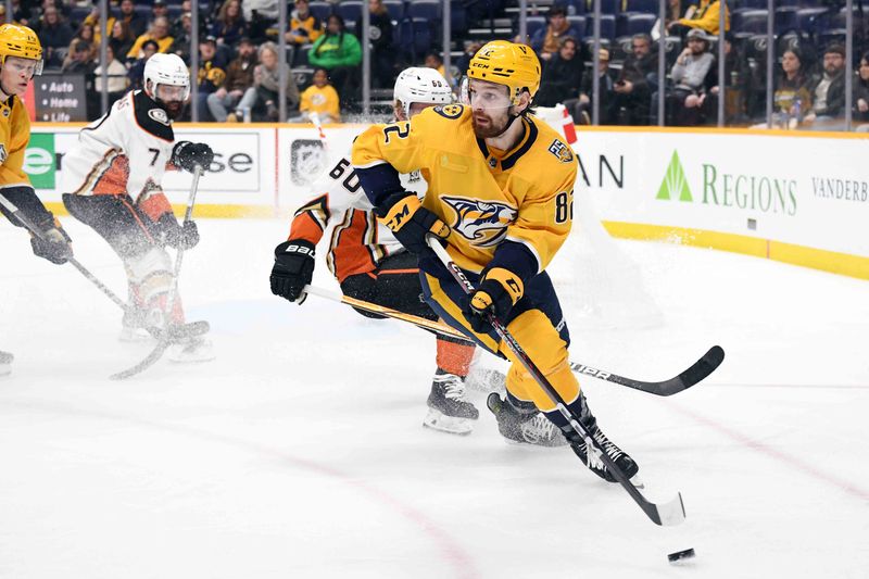 Jan 9, 2024; Nashville, Tennessee, USA; Nashville Predators center Tommy Novak (82) handles the puck in the corner during the third period against the Anaheim Ducks at Bridgestone Arena. Mandatory Credit: Christopher Hanewinckel-USA TODAY Sports