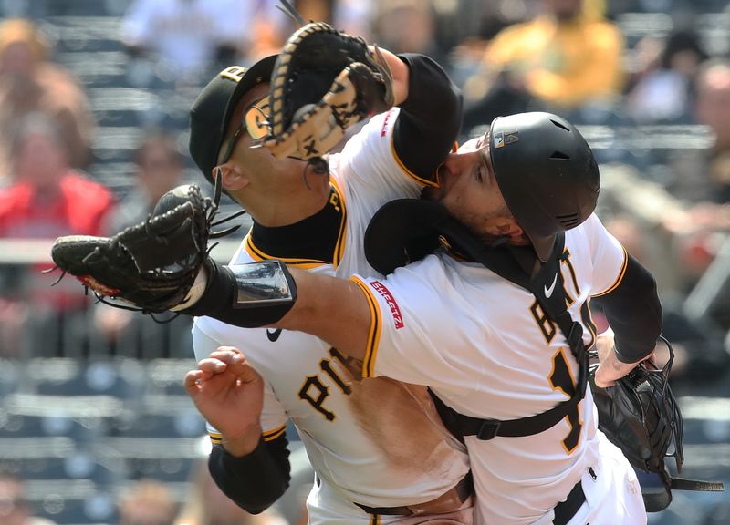 Apr 9, 2025; Pittsburgh, Pennsylvania, USA;  Pittsburgh Pirates first baseman Endy Rodriguez (5) and catcher Joey Bart (14) collide attempting to catch a pop-up hit by St. Louis Cardinals designated hitter Willson Contreras (not pictured) during the eighth inning at PNC Park. Mandatory Credit: Charles LeClaire-Imagn Images