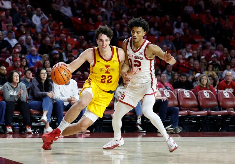 Jan 6, 2024; Norman, Oklahoma, USA; Iowa State Cyclones forward Milan Momcilovic (22) drives to the basket around Oklahoma Sooners guard Milos Uzan (12) during the first half at Lloyd Noble Center. Mandatory Credit: Alonzo Adams-USA TODAY Sports