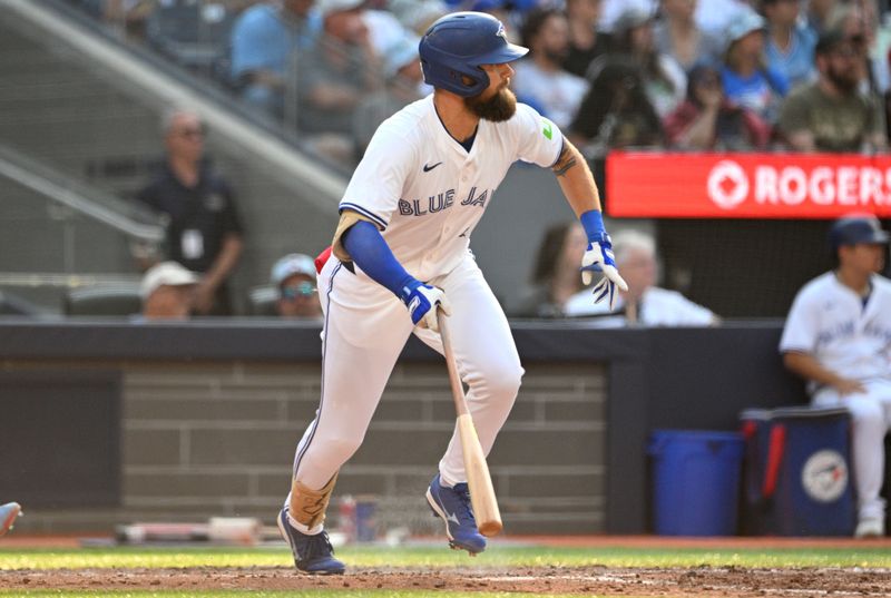 Sep 14, 2024; Toronto, Ontario, CAN;  Toronto Blue Jays center fielder Nathan Lukes (38) hits a single against the St. Louis Cardinals in the sixth inning at Rogers Centre. Mandatory Credit: Dan Hamilton-Imagn Images