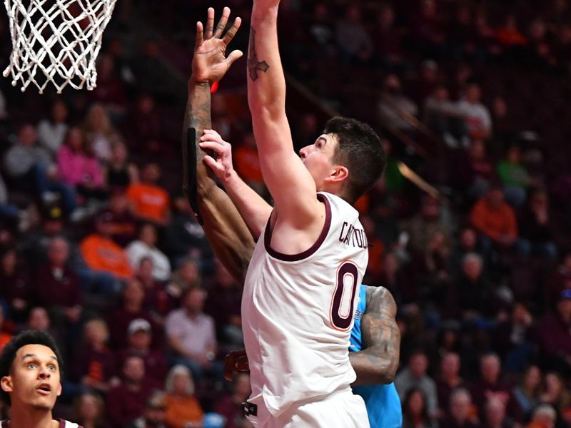 Feb 13, 2024; Blacksburg, Virginia, USA; Virginia Tech Hokies guard Hunter Cattoor (0) goes in for a layup during the second half at Cassell Coliseum. Mandatory Credit: Brian Bishop-USA TODAY Sports