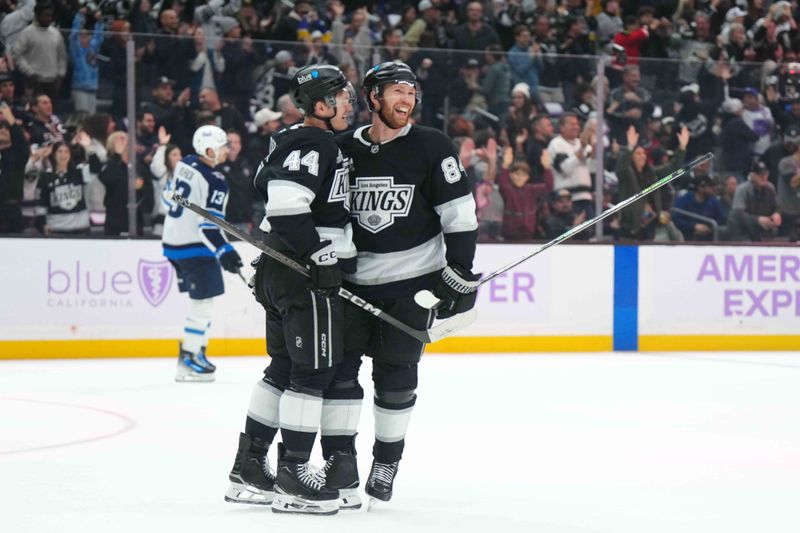 Nov 27, 2024; Los Angeles, California, USA; LA Kings defenseman Mikey Anderson (44) and defenseman Vladislav Gavrikov (84) celebrate after a goal against the Winnipeg Jets in the third period at Crypto.com Arena. Mandatory Credit: Kirby Lee-Imagn Images