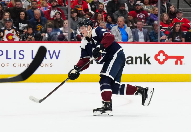 Mar 4, 2024; Denver, Colorado, USA; Colorado Avalanche defenseman Cale Makar (8) shoots and scores a goal in the second period against the Chicago Blackhawks at Ball Arena. Mandatory Credit: Ron Chenoy-USA TODAY Sports