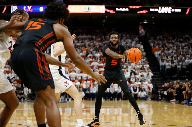 Feb 5, 2024; Charlottesville, Virginia, USA; Miami (Fl) Hurricanes guard Wooga Poplar (5) passes the ball to Hurricanes forward Norchad Omier (15) against the Virginia Cavaliers during the first half at John Paul Jones Arena. Mandatory Credit: Amber Searls-USA TODAY Sports