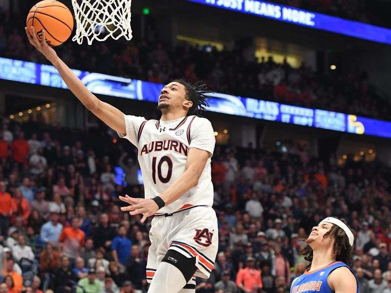 Mar 17, 2024; Nashville, TN, USA; Auburn Tigers guard Chad Baker-Mazara (10) shoots against Florida Gators guard Walter Clayton Jr. (1) in the first half in the SEC Tournament championship game at Bridgestone Arena. Mandatory Credit: Christopher Hanewinckel-USA TODAY Sports