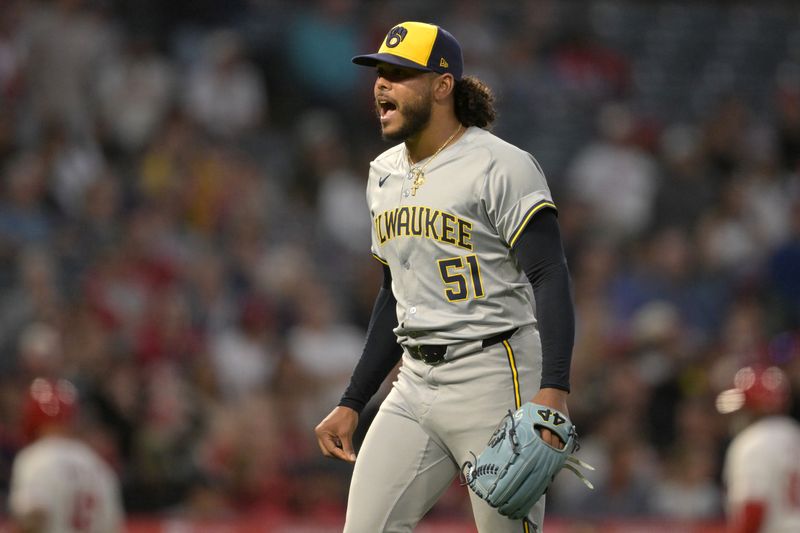 Jun 19, 2024; Anaheim, California, USA;  Milwaukee Brewers starting pitcher Freddy Peralta (51) reacts after getting Los Angeles Angels catcher Logan O'Hoppe (14) to ground out in the sixth inning leaving two runners on base at Angel Stadium. Mandatory Credit: Jayne Kamin-Oncea-USA TODAY Sports