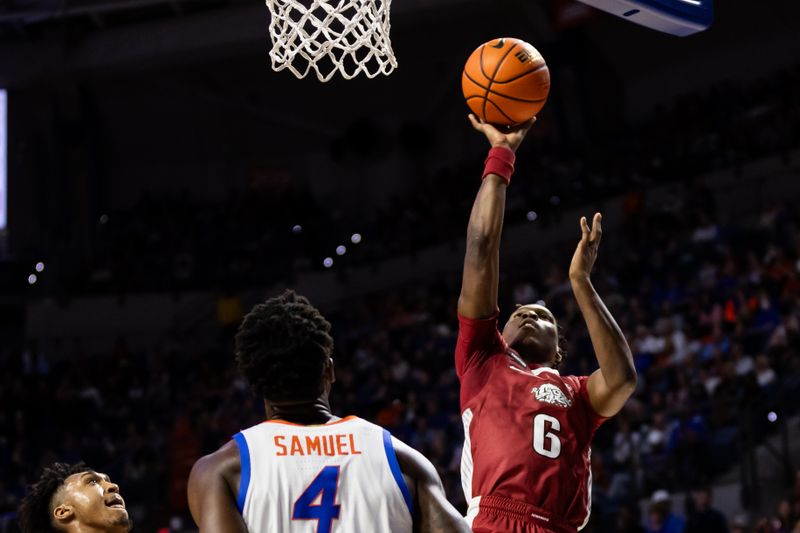 Jan 13, 2024; Gainesville, Florida, USA; Arkansas Razorbacks guard Layden Blocker (6) shoots the ball over Florida Gators forward Tyrese Samuel (4) during the first half at Exactech Arena at the Stephen C. O'Connell Center. Mandatory Credit: Matt Pendleton-USA TODAY Sports