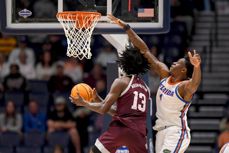 Mar 16, 2024; Nashville, TN, USA;  Texas A&M Aggies forward Solomon Washington (13) goes up and under Florida Gators guard Walter Clayton Jr. (1) during the second half at Bridgestone Arena. Mandatory Credit: Steve Roberts-USA TODAY Sports