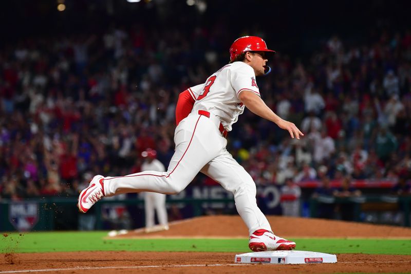 Jun 24, 2025; Anaheim, California, USA; Los Angeles Angels pinch runner Scott Kingery (13) rounds third to score against the Boston Red Sox during the tenth inning at Angel Stadium. Mandatory Credit: Gary A. Vasquez-Imagn Images