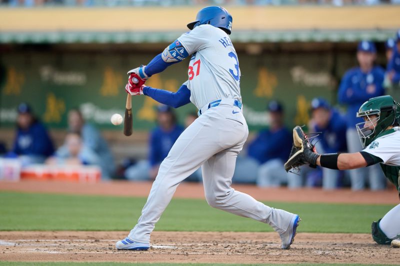 Aug 3, 2024; Oakland, California, USA; Los Angeles Dodgers outfielder Teoscar Hernandez (37) hits a double against the Oakland Athletics during the third inning at Oakland-Alameda County Coliseum. Mandatory Credit: Robert Edwards-USA TODAY Sports