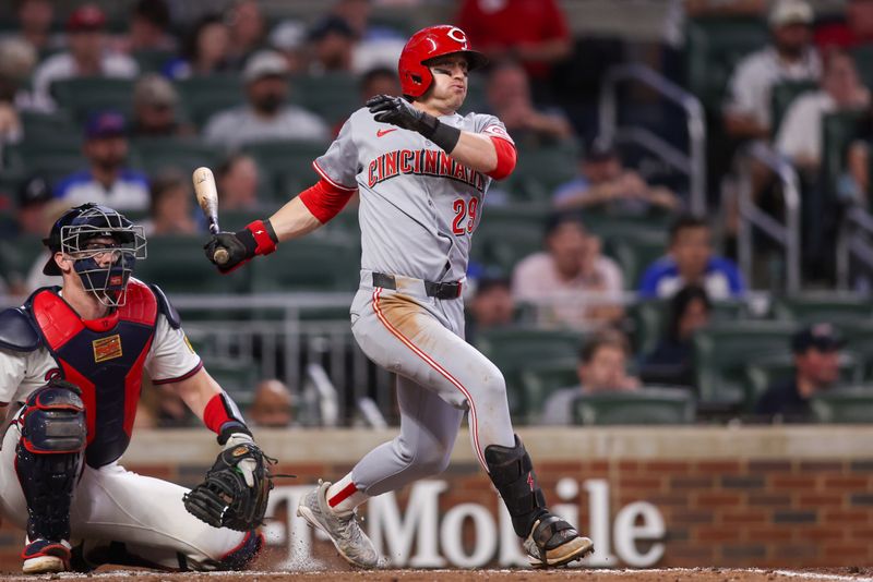 May 8, 2025; Atlanta, Georgia, USA; Cincinnati Reds center fielder TJ Friedl (29) hits an RBI single against the Atlanta Braves in the seventh inning at Truist Park. Mandatory Credit: Brett Davis-Imagn Images