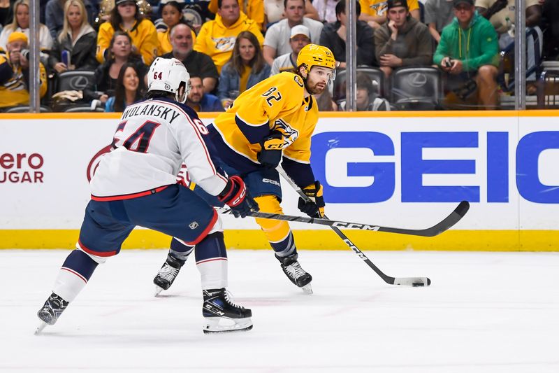 Apr 13, 2024; Nashville, Tennessee, USA; Nashville Predators center Tommy Novak (82) shoots and scores against the Columbus Blue Jackets during the first period at Bridgestone Arena. Mandatory Credit: Steve Roberts-USA TODAY Sports