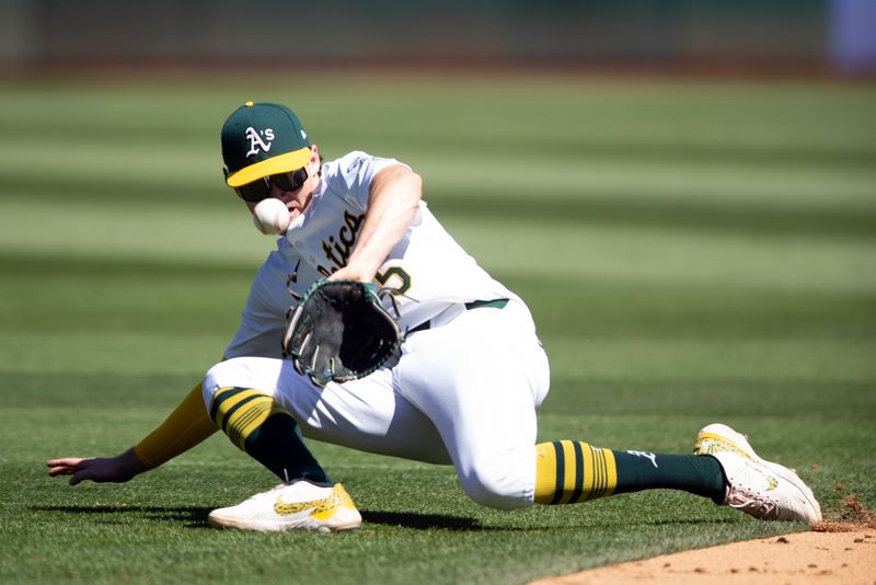 Sep 5, 2024; Oakland, California, USA; Oakland Athletics shortstop Jacob Wilson (5) cannot get a glove on a ground ball by Seattle Mariners right fielder Mitch Haniger during the sixth inning at Oakland-Alameda County Coliseum. Mandatory Credit: D. Ross Cameron-Imagn Images