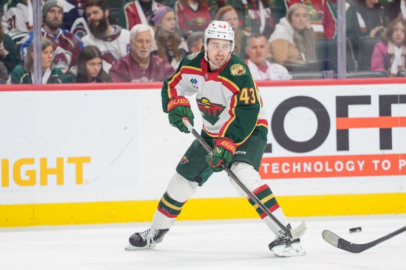 Dec 21, 2025; Saint Paul, Minnesota, USA; Minnesota Wild defenseman Quinn Hughes (43) clears the puck in the first period against the Colorado Avalanche at Grand Casino Arena. Mandatory Credit: Matt Blewett-Imagn Images
