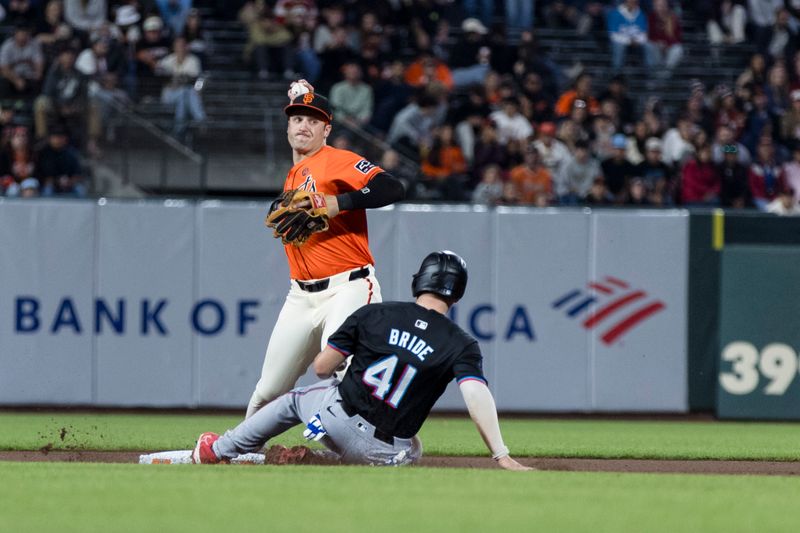 Aug 30, 2024; San Francisco, California, USA; San Francisco Giants second baseman Casey Schmitt (10) forces out Miami Marlins first baseman Jonah Bride (41) but throws too late for a double play during the fourth inning at Oracle Park. Mandatory Credit: John Hefti-USA TODAY Sports