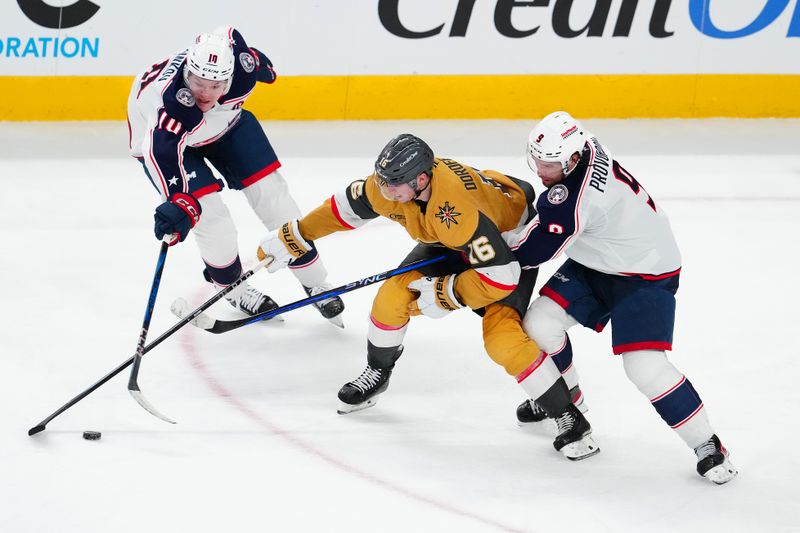 Jan 30, 2025; Las Vegas, Nevada, USA; Vegas Golden Knights left wing Pavel Dorofeyev (16) looks to control the puck between Columbus Blue Jackets left wing Dmitri Voronkov (10) and Columbus Blue Jackets defenseman Ivan Provorov (9) during the third period at T-Mobile Arena. Mandatory Credit: Stephen R. Sylvanie-Imagn Images