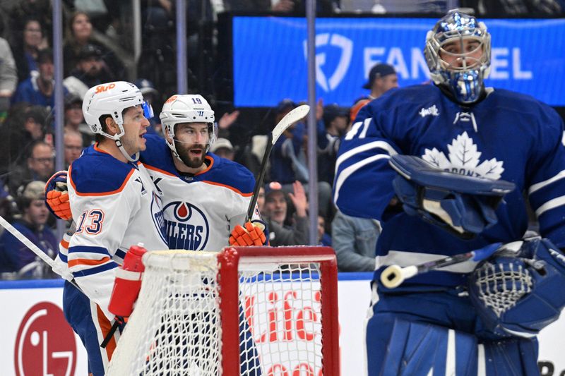 Nov 16, 2024; Toronto, Ontario, CAN;  Edmonton Oilers forward Adam Henrique (19) celebrates with forward Mattias Janmark (13) after scoring a goal against Toronto Maple Leafs goalie Anthony Stolarz (41) in the first period at Scotiabank Arena. Mandatory Credit: Dan Hamilton-Imagn Images