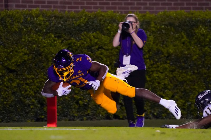 Sep 25, 2021; Greenville, North Carolina, USA;  East Carolina Pirates cornerback Ja'Quan McMillian (21) scores a touchdown on his interception return against Charleston Southern Buccaneers during the second half at Dowdy-Ficklen Stadium. Mandatory Credit: James Guillory-USA TODAY Sports