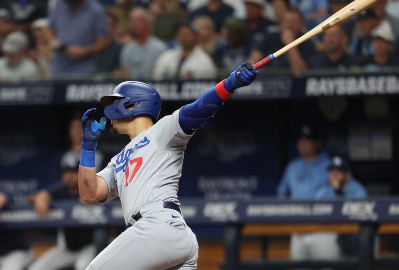 May 28, 2023; St. Petersburg, Florida, USA; Los Angeles Dodgers second baseman Miguel Vargas (17) hits a sacrifice RBI against the Tampa Bay Rays 
during the third inning at Tropicana Field. Mandatory Credit: Kim Klement-USA TODAY Sports