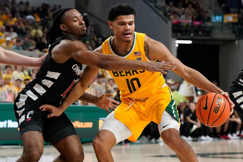 Jan 13, 2024; Waco, Texas, USA; Baylor Bears guard RayJ Dennis (10) is defended  by Cincinnati Bearcats guard Day Day Thomas (1) during the second half at Paul and Alejandra Foster Pavilion. Mandatory Credit: Raymond Carlin III-USA TODAY Sports