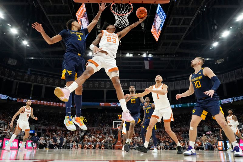 Feb 11, 2023; Austin, Texas, USA; Texas Longhorns forward Dillon Mitchell (23) shoots around West Virginia Mountaineers forward Tre Mitchell (3) during the second half at Moody Center. Mandatory Credit: Scott Wachter-USA TODAY Sports