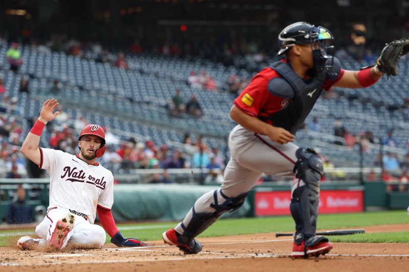 Sep 16, 2025; Washington, District of Columbia, USA; Washington Nationals outfielder Dylan Crews (3) slides across home plate to score a run on an RBI single by Nationals outfielder Jacob Young (not pictured) ahead of a throw to Atlanta Braves catcher Drake Baldwin (30) during the second inning at Nationals Park. Mandatory Credit: Geoff Burke-Imagn Images
