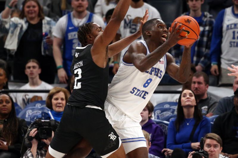 Jan 31, 2024; Memphis, Tennessee, USA; Memphis Tigers forward David Jones (8) drives to the basket as Rice Owls guard Mekhi Mason (2) defends during the second half at FedExForum. Mandatory Credit: Petre Thomas-USA TODAY Sports