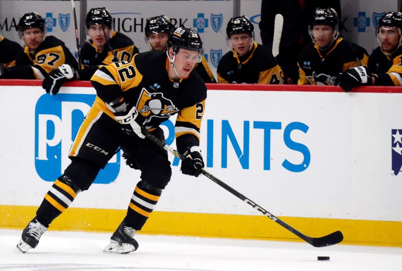 Mar 26, 2024; Pittsburgh, Pennsylvania, USA; Pittsburgh Penguins right wing Sam Poulin (22) skates up ice with the puck against  the Carolina Hurricanes at PPG Paints Arena. Mandatory Credit: Charles LeClaire-USA TODAY Sports