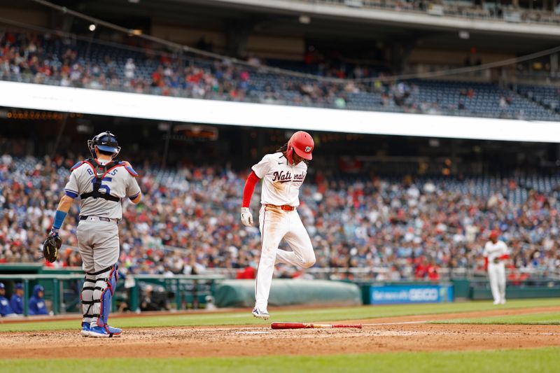 Apr 25, 2024; Washington, District of Columbia, USA; Washington Nationals shortstop CJ Abrams (5) scores a run on a single by Nationals first baseman Joey Meneses (45) against the Los Angeles Dodgers during the eighth inning at Nationals Park. Mandatory Credit: Geoff Burke-USA TODAY Sports