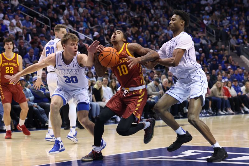 Jan 16, 2024; Provo, Utah, USA; Iowa State Cyclones guard Keshon Gilbert (10) goes to the basket between Brigham Young Cougars guard Dallin Hall (30) and guard Jaxson Robinson (2) during the second half at Marriott Center. Mandatory Credit: Rob Gray-USA TODAY Sports