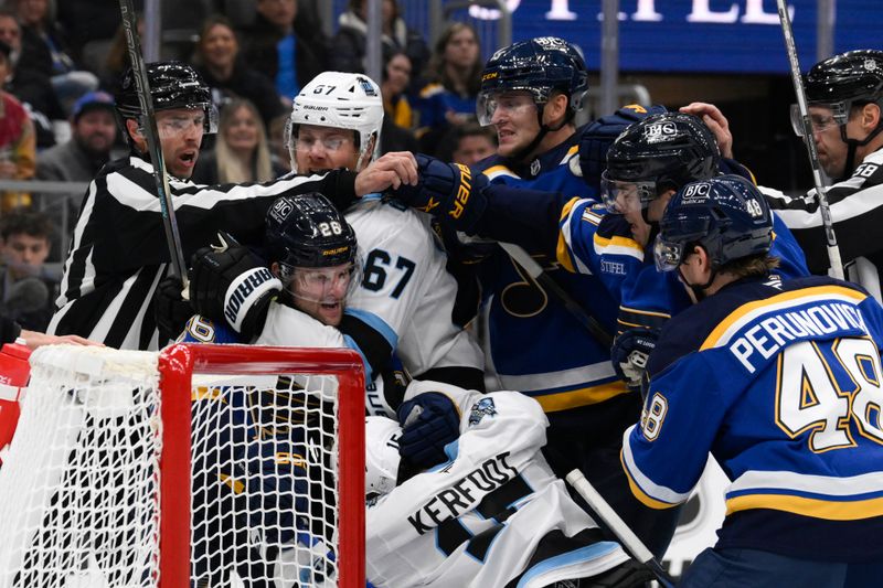 Nov 7, 2024; St. Louis, Missouri, USA; Utah Hockey Club left wing Lawson Crouse (67) scuffles with St. Louis Blues left wing Nathan Walker (26) during the first period at Enterprise Center. Mandatory Credit: Jeff Le-Imagn Images