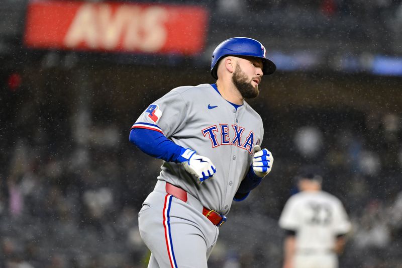 May 21, 2025; Bronx, New York, USA; Texas Rangers first baseman Jake Burger (21) runs the bases after hitting a solo home run against the New York Yankees during the fifth inning at Yankee Stadium. Mandatory Credit: John Jones-Imagn Images