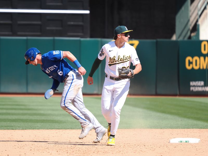 Aug 23, 2023; Oakland, California, USA; Oakland Athletics second baseman Zack Gelof (20) turns a double play against Kansas City Royals center fielder Drew Waters (6) during the ninth inning at Oakland-Alameda County Coliseum. Mandatory Credit: Kelley L Cox-USA TODAY Sports