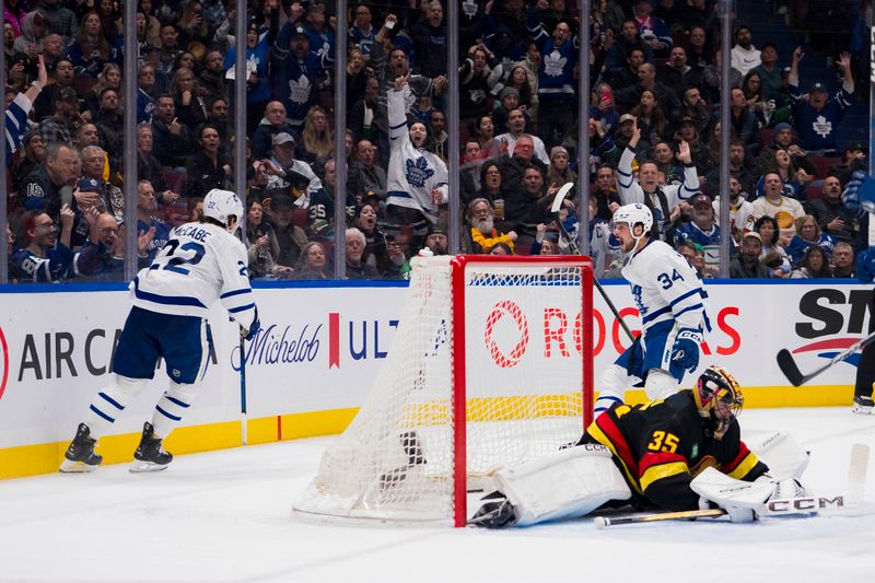 Jan 20, 2024; Vancouver, British Columbia, CAN; Toronto Maple Leafs defenseman Jake McCabe (22) and forward Auston Matthews (34) celebrate MCabe   s goal socred on Vancouver Canucks goalie Thatcher Demko (35) in the second period at Rogers Arena. Mandatory Credit: Bob Frid-USA TODAY Sports